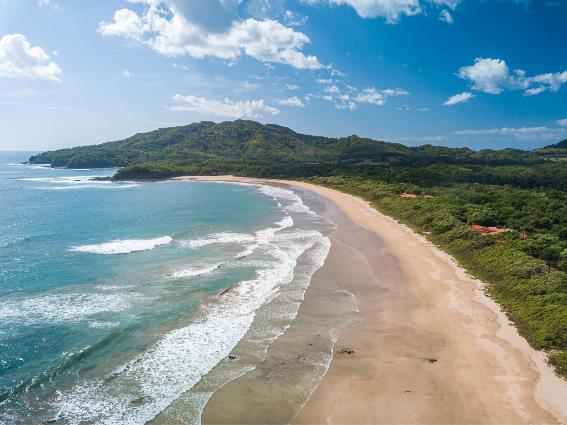 Una de las mejores playas de Costa Rica, la costa curva de playa única de Playa Grande y la arena fina capturada en un día parcialmente nublado